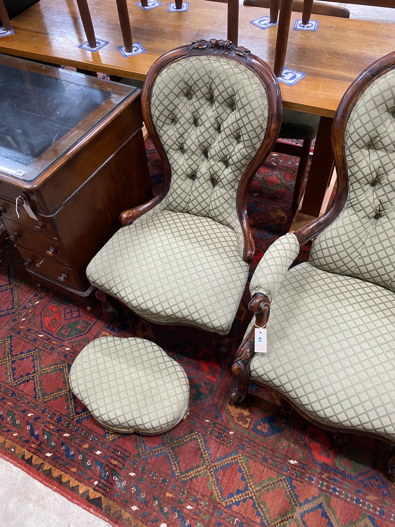 A pair of Victorian carved walnut spoon back chairs, one with arms together with a similar footstool